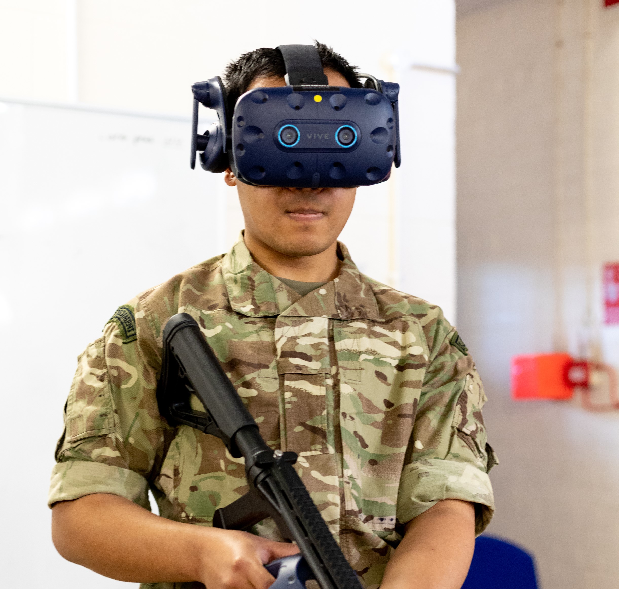 Image shows RAF personnel wearing virtual reality headset and rifle.
